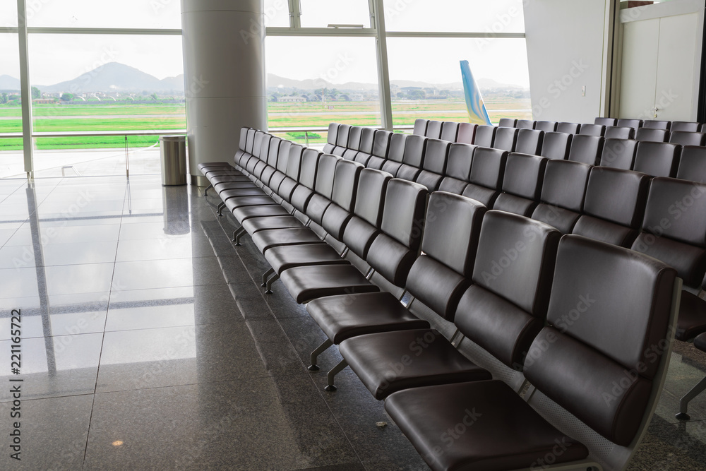 Fototapeta premium Chairs, benches, Seat Waiting lined for Departure passengers in airport and the taxi way and runway back ground.
