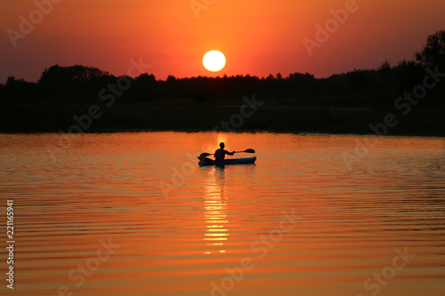 Fototapeta Naklejka Na Ścianę i Meble -  active, sports, sunset, kayak, water, recreation, romance, color, orange, wave, water sports, scarf, see, evening, boat, sailing, canoeing, mazury, fun, person, summer, holidays, dawn, swimmer