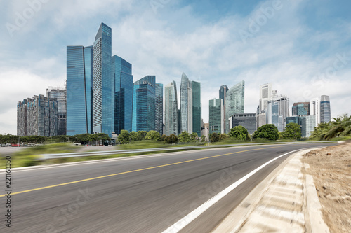 empty asphalt highway through modern city