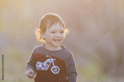 cute baby boy in sunset light photo