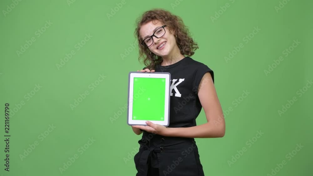 Young happy beautiful nerd woman showing digital tablet