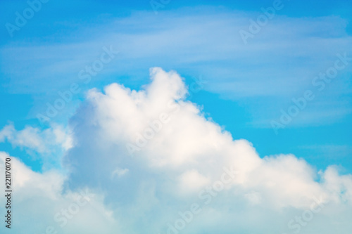 White cumulus fluffy clouds against a bright azure sky (background) © Mikhail