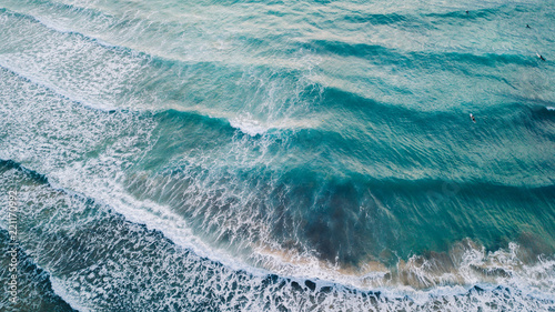 Scenic aerial view of beautiful clear turquoise sea water with waves and white foam hitting the shore. Mediterranean. Malta