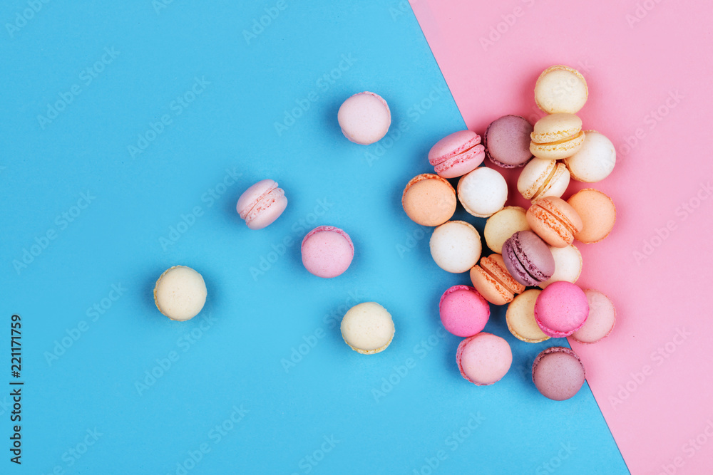 Cake macaron or macaroon on pink and blue background.