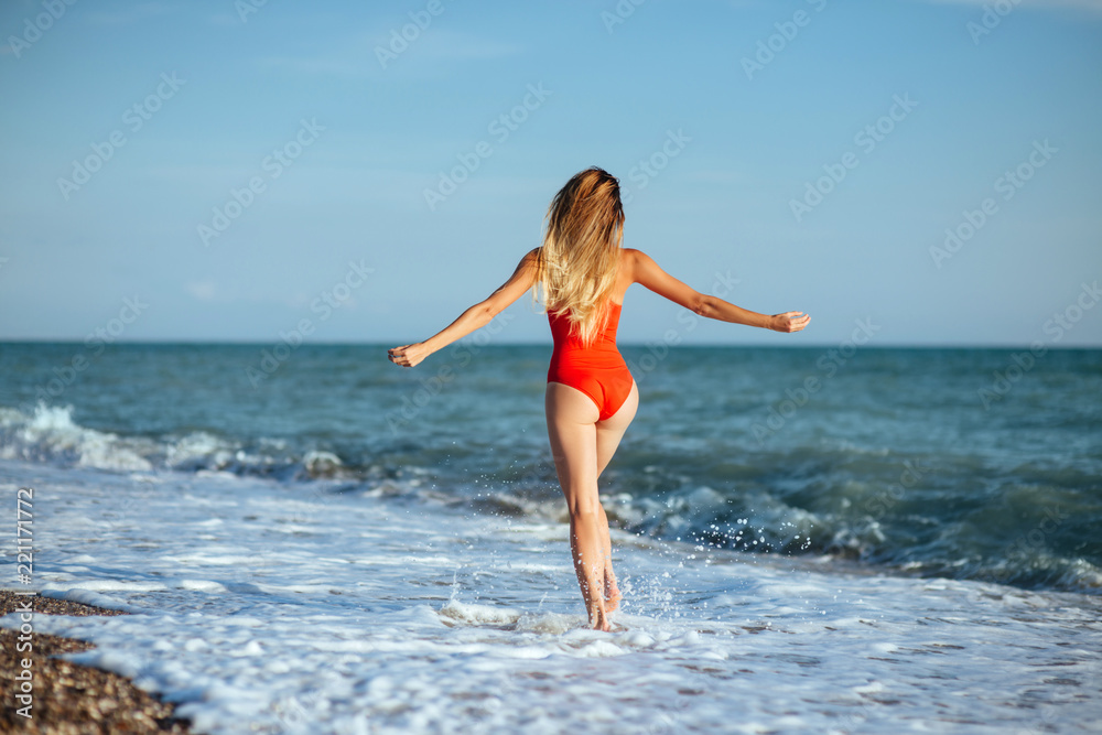 young longhaired girl in red swimsuit young longhaired girl in red swimsuit