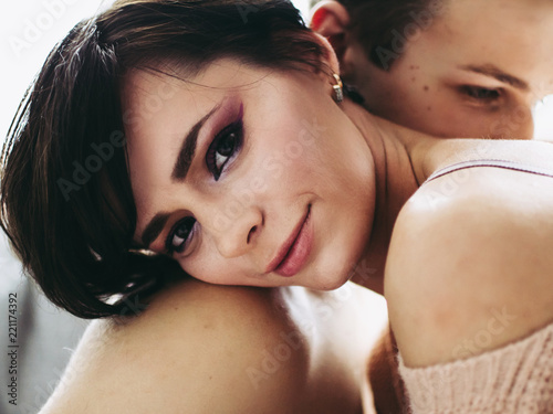 Close-up of young romantic couple is kissing and enjoying the company of each other at home