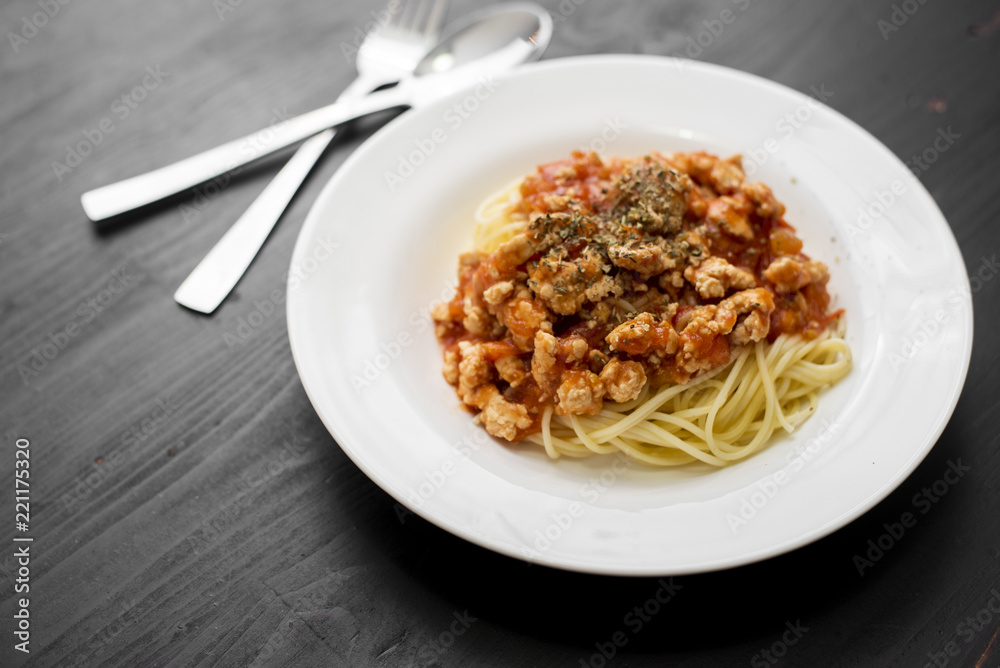 Spaghetti on black wooden background