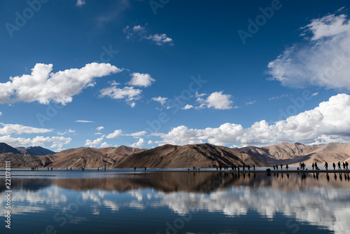 Himalaya mountain at Pangong Lake with reflection on water and people