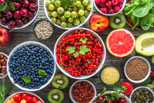 Healthy food selection. Superfoods  fresh organic fruits  assortment of berries  nuts and seeds. Detox antioxidant diet with vegetarian ingredients.