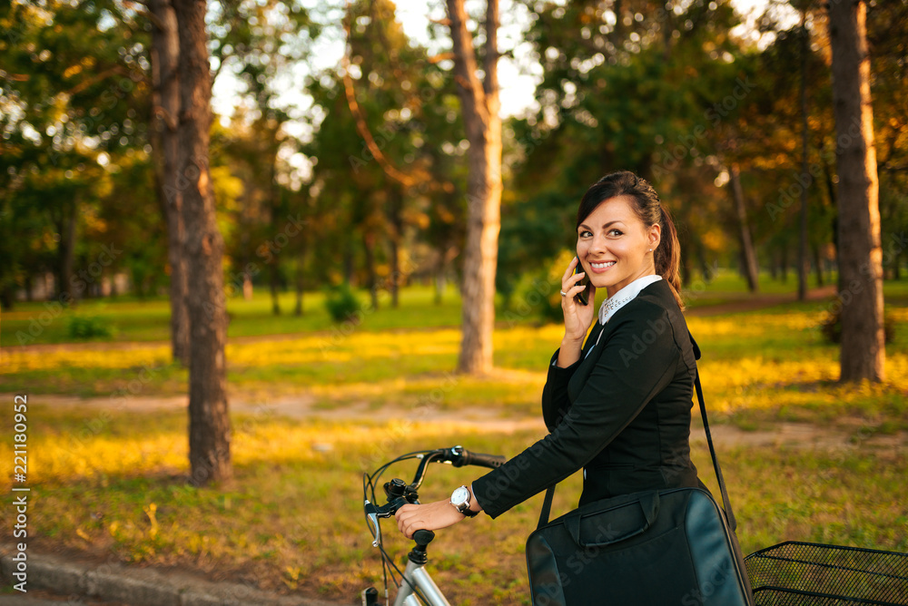 Healthy lifestyle concept. Businesswoman riding a bicycle in the park. Healthy lifestyle concept. Businesswoman riding a bicycle in the park.