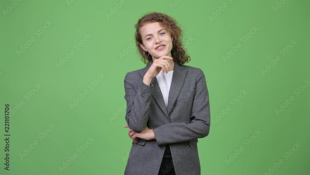 Young happy beautiful businesswoman thinking and looking up Young happy beautiful businesswoman thinking and looking up
