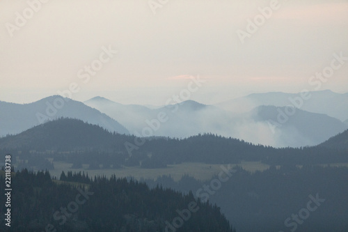 Mountains with trees, clouds and haze