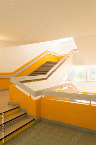 Interior large staircase with yellow bright colors and light