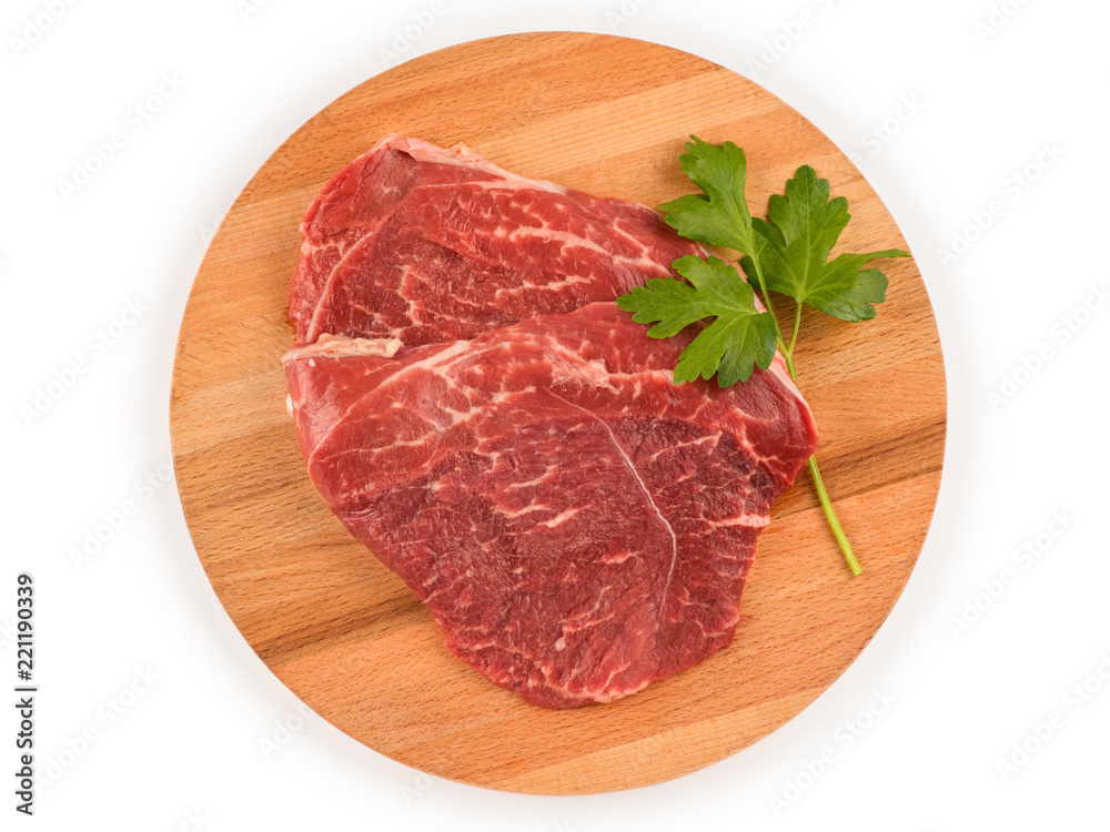 Raw meat for steak on wooden cutting board. Top view isolated with clipping path Raw meat for steak on wooden cutting board. Top view isolated with clipping path