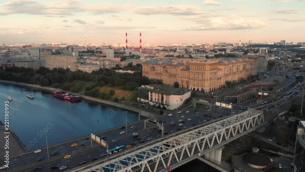 Flight of the camera over the high-rise buildings, traffic and lights of cars on multi-lane highways. Bright red sunset over the city and dramatic clouds and road junction in Moscow. Flight of the camera over the high-rise buildings, traffic and lights of cars on multi-lane highways. Bright red sunset over the city and dramatic clouds and road junction in Moscow.