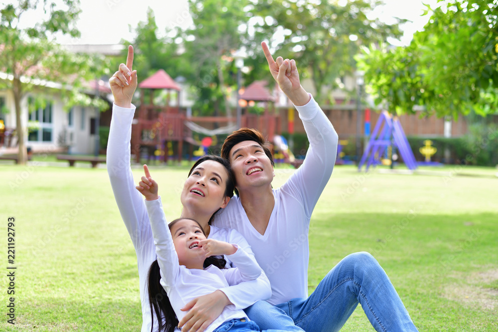 Obraz premium Family Concept. Family is doing happy activities at Playground. Parents with children are playing in the garden.