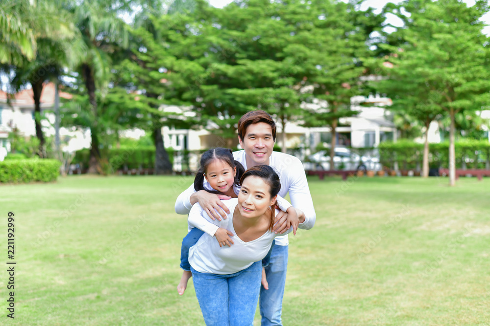Family Concept. Family is doing happy activities at Playground. Parents with children are playing in the garden. Family Concept. Family is doing happy activities at Playground. Parents with children are playing in the garden.