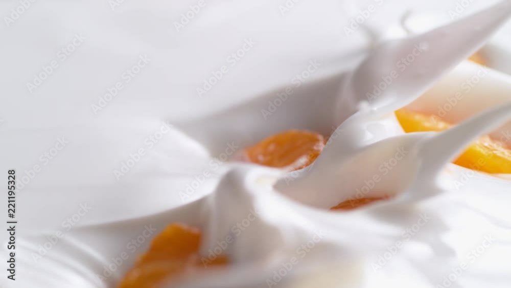 Tossing mandarine orange in yoghurt. Shot with high speed camera, phantom flex 4K. Slow Motion.