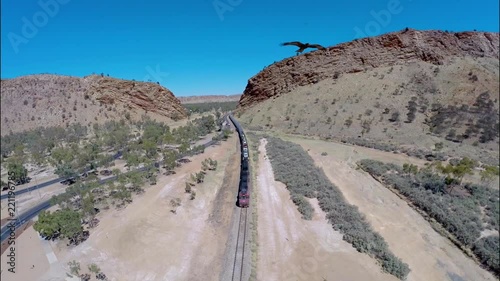 Aerial Drone Shot of Alice Springs Train Arriving in Canyon, Eagle Swoops, Red Centre Australia photo