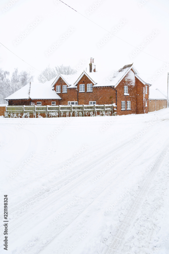 Farmhouse in winter snow, UK