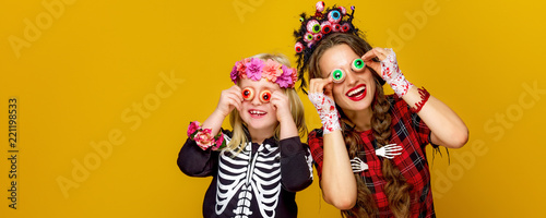 mother and daughter in halloween costume having fun time