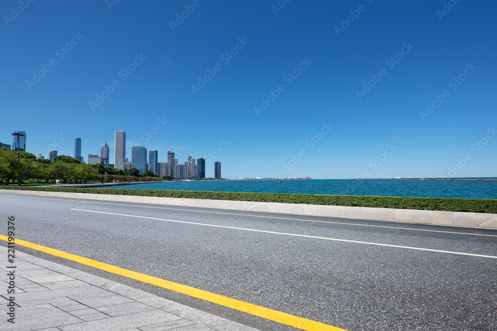 asphalt highway with modern city in chicago asphalt highway with modern city in chicago