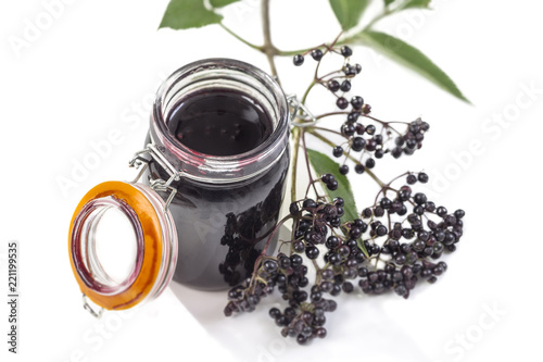 Elderberry Jam. Jar of homemade elderberry confiture and fresh fruits on white background