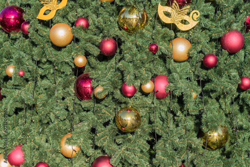 Christmas and New Year holidays background. Christmas tree decorated with balls and garlands Christmas and New Year holidays background. Christmas tree decorated with balls and garlands