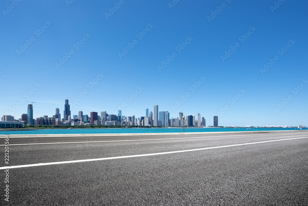 asphalt highway with modern city in chicago asphalt highway with modern city in chicago