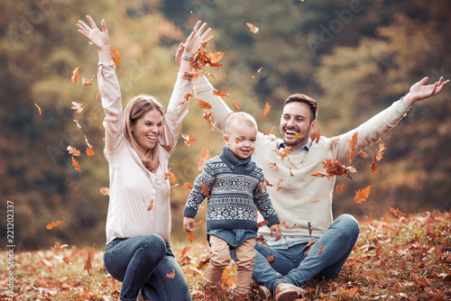 Happy family having fun in autumn forest