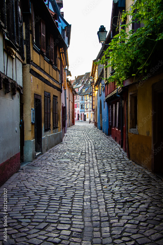 Fototapeta premium Sunrise in the old town of Colmar, Alsace, France on a sunny day. Small street and traditional half timbered houses. Also known as Petit Venice.