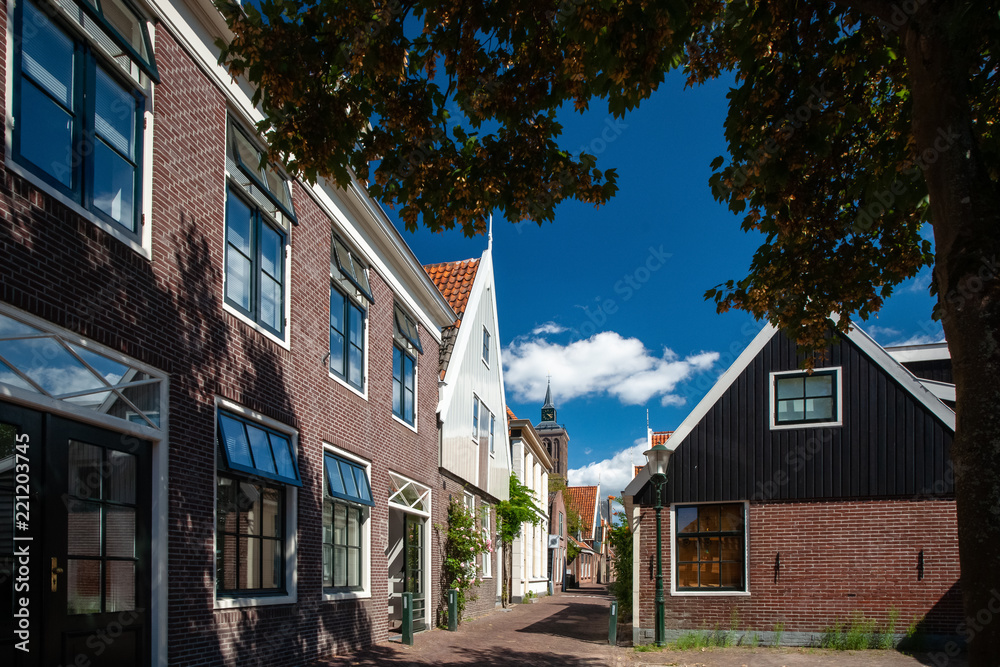 Traditional Dutch houses of wood built with typical architecture and painted with bright colors.