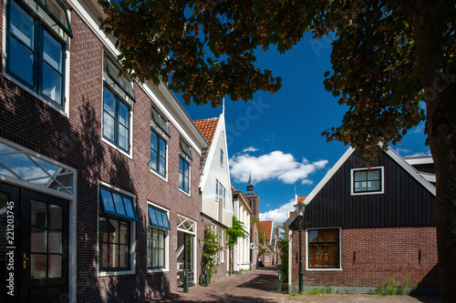 Traditional Dutch houses of wood built with typical architecture and painted with bright colors.