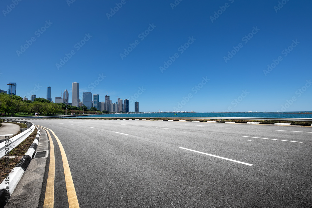 asphalt highway with modern city in chicago asphalt highway with modern city in chicago