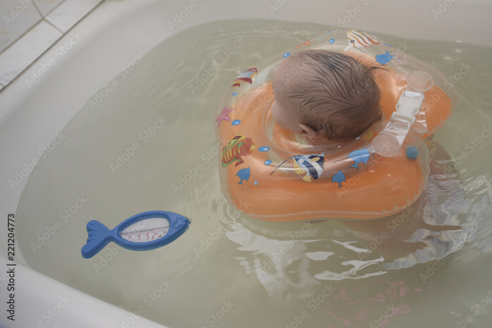 child with a circle bathing in the bathroom child with a circle bathing in the bathroom