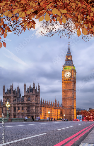 Buses with autumn leaves against Big Ben in London  England  UK