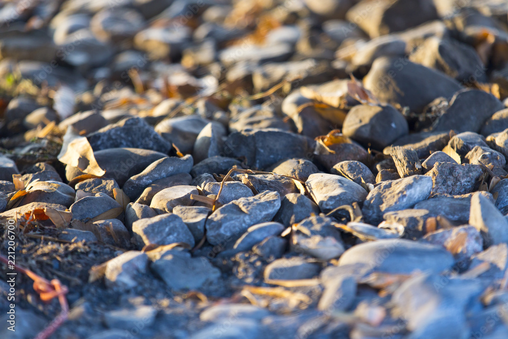 background, small stones on the ground under the sunset