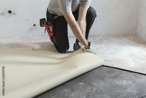 Contractor removing an old linoleum flooring photo