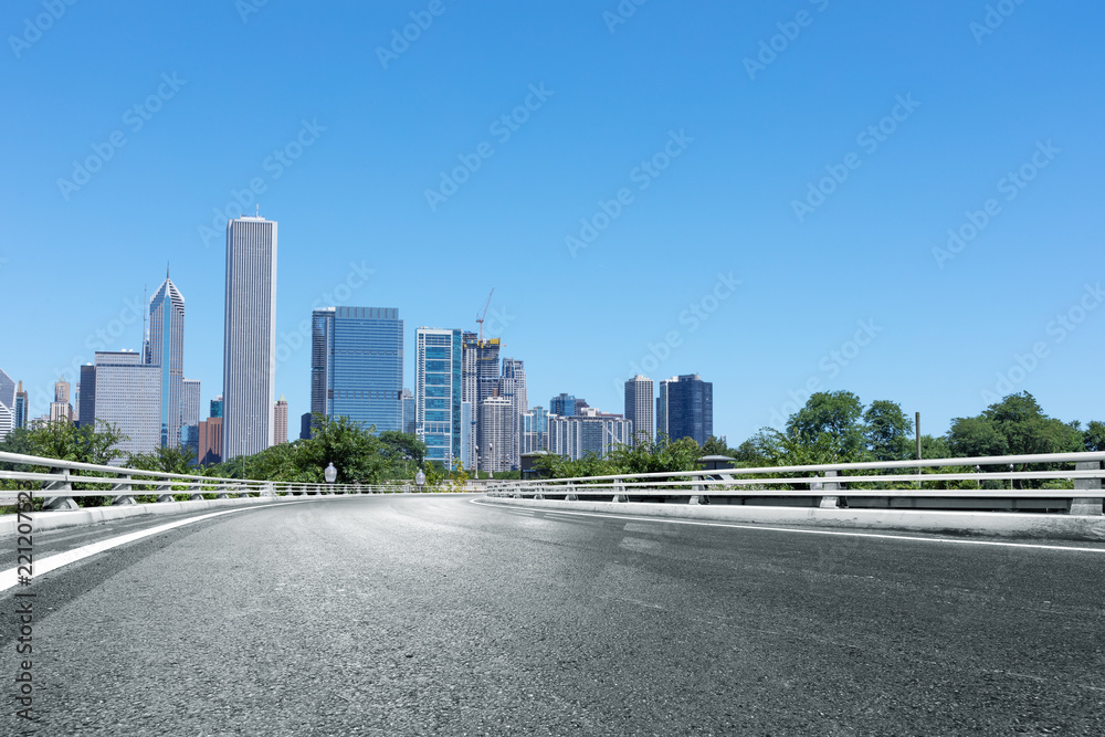 asphalt highway with modern city in chicago asphalt highway with modern city in chicago