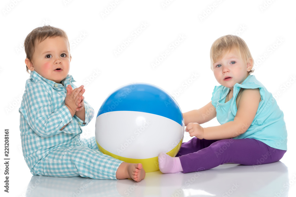 Toddler boy and girl playing with ball. Toddler boy and girl playing with ball.