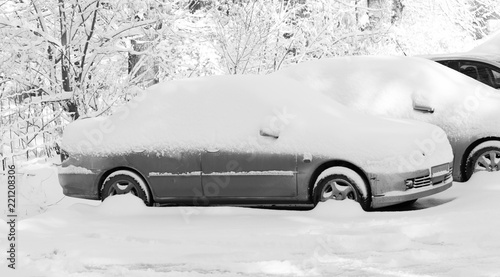 Car under the snow in the city