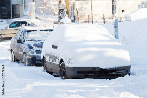 Car under the snow in the city