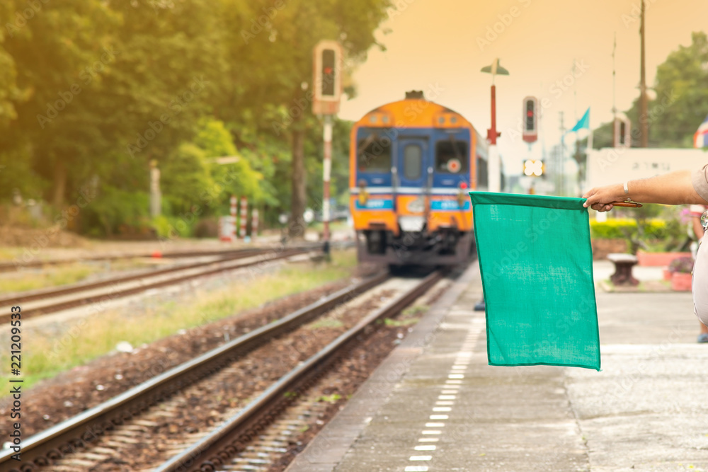 Railway officials raise the flag to display the symbol as safe. After the train leaves the station.