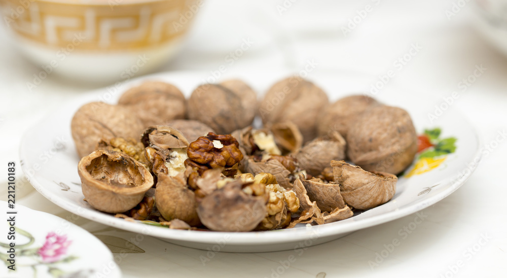 on the table a walnut in a plate on the table a walnut in a plate