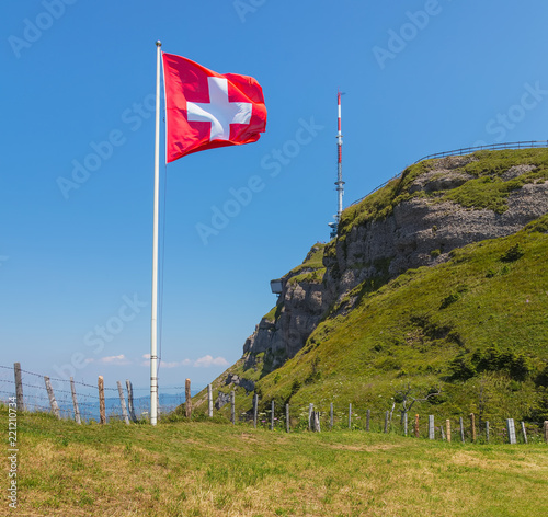 Flag of Switzerland on Mt. Rigi in Switzerland. The Rigi is a popular tourist destination, accessible by a mountain rack railway.