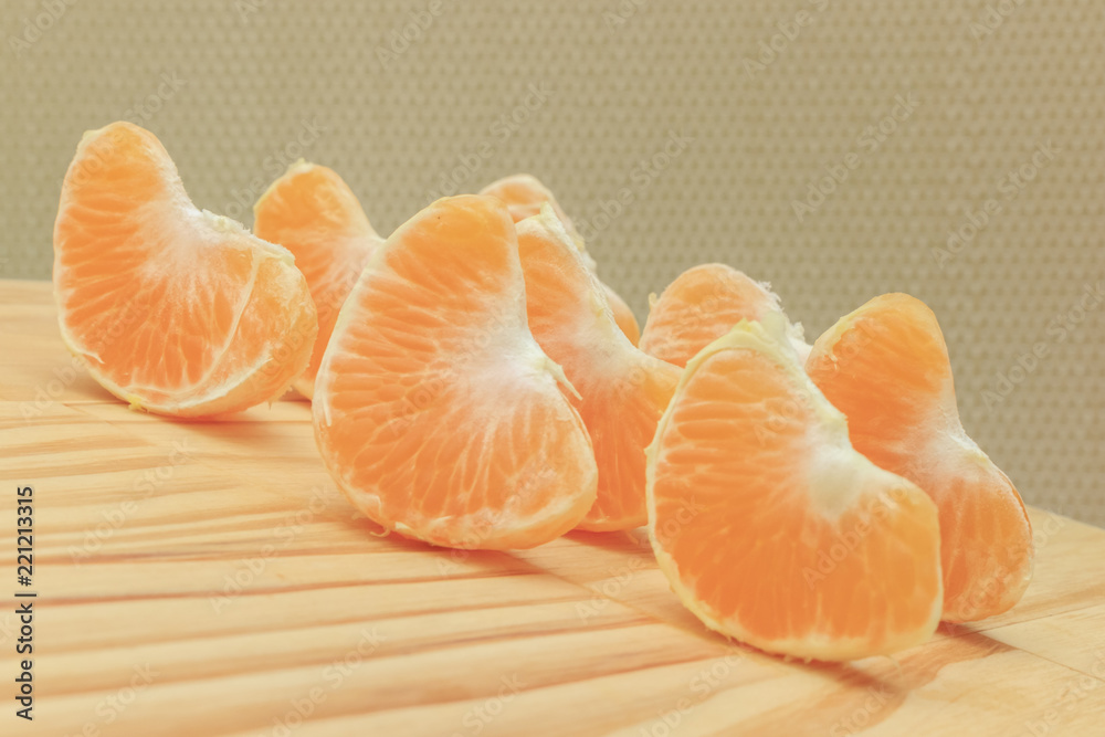 tangerine wedges on wooden board tangerine wedges on wooden board