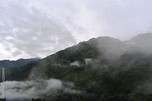 lush green mountains with clouds