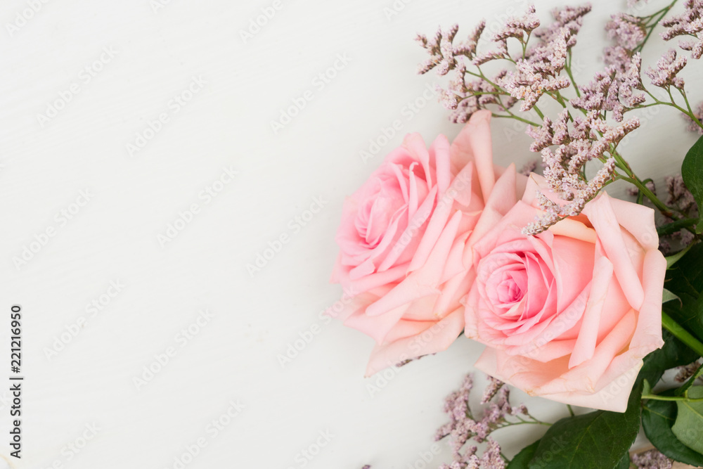 Two rose fresh flowers on table from above with copy space Two rose fresh flowers on table from above with copy space