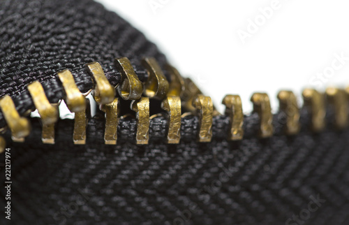 Close-up of a metal zipper on a white background