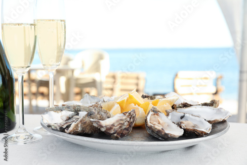 Fresh oysters with cut juicy lemon served on table